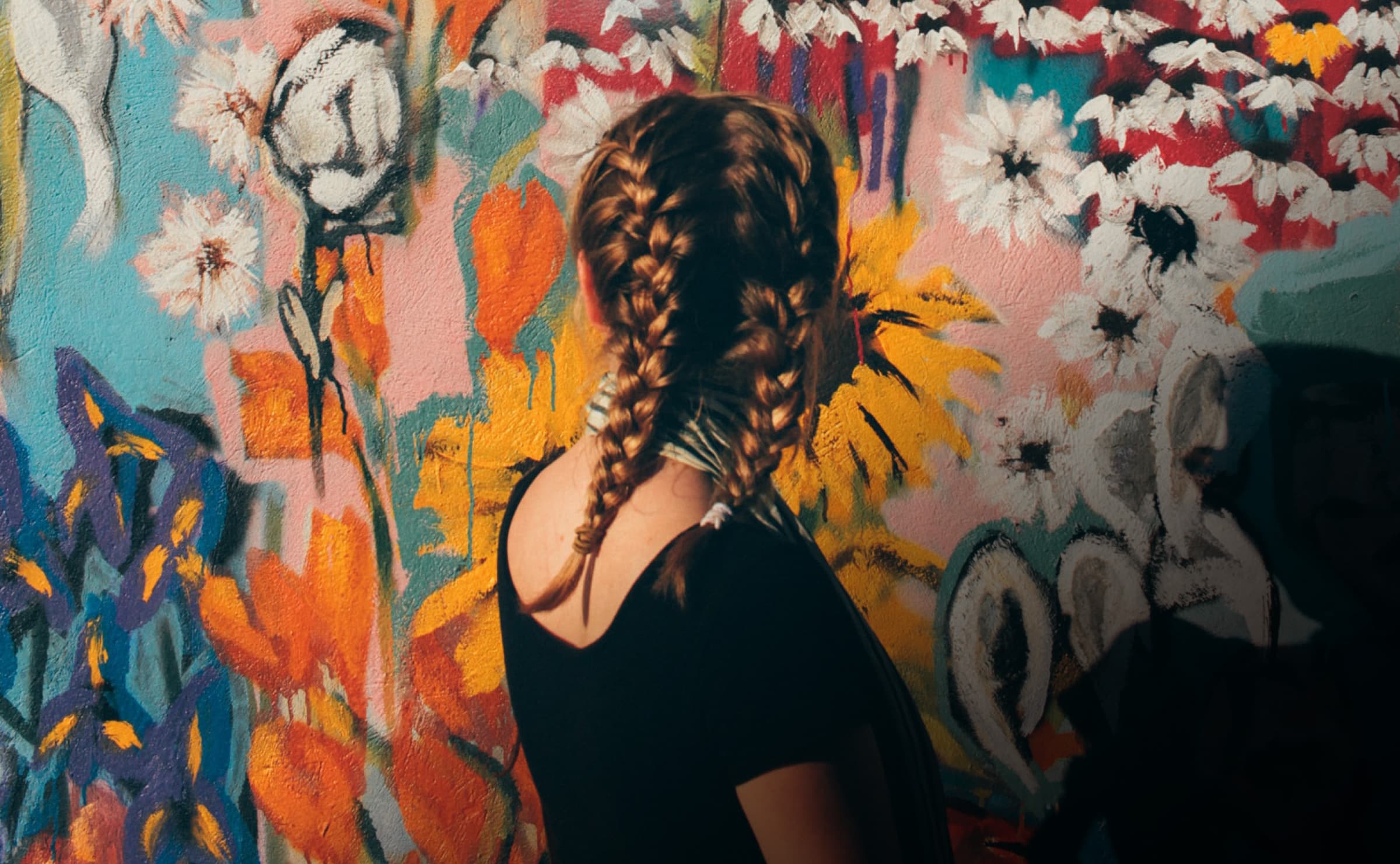 girl looking at painted wall